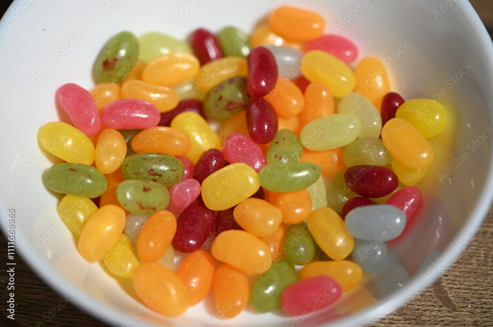Colorful jelly beans in plastic bag on wooden table. Selective focus. Colorful jelly beans in plastic bag on wooden table. Selective focus.