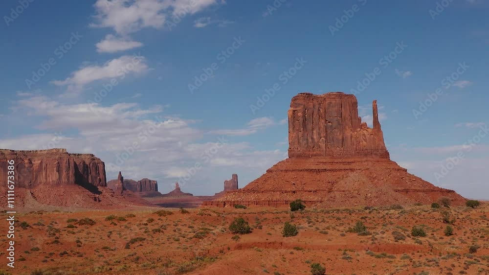 Stunning rock formations rise dramatically from the arid desert landscape of Monument Valley, showcasing nature's beauty in perfect sunlight. Stunning rock formations rise dramatically from the arid desert landscape of Monument Valley, showcasing nature's beauty in perfect sunlight.