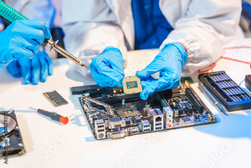Close-up of a technician wearing gloves soldering electronic components at a desk in an office. The scene highlights precision, technical expertise, and focused work in an electronics lab setting