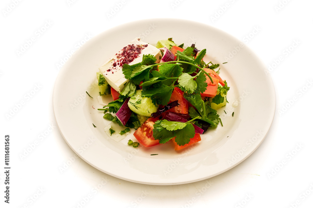 A plate of salad with tomatoes, cucumbers, and onions A plate of salad with tomatoes, cucumbers, and onions