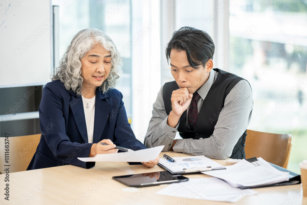 Executives are having a meeting with employees to discuss business planning in a conference room. Executives are having a meeting with employees to discuss business planning in a conference room.