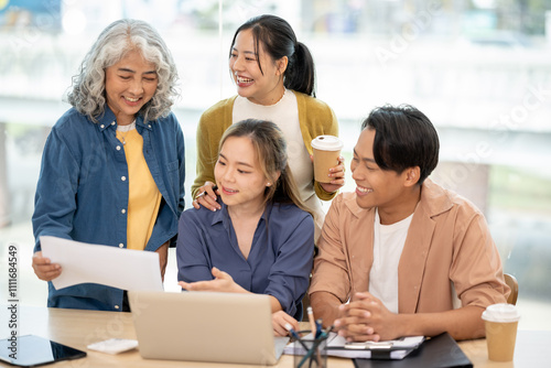 An Asian business startup team brainstorming, sharing creative and helpful ideas, and discussing a project in a modern office. A senior female boss works with young employees in the office.