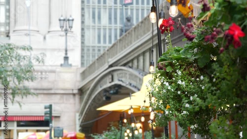 New York City Grand Central Terminal railway station, 42 street. Manhattan Midtown. Bridge on Pershing Square, NYC, USA. American urban scene, United States. Light bulb garland, umbrellas and flowers.