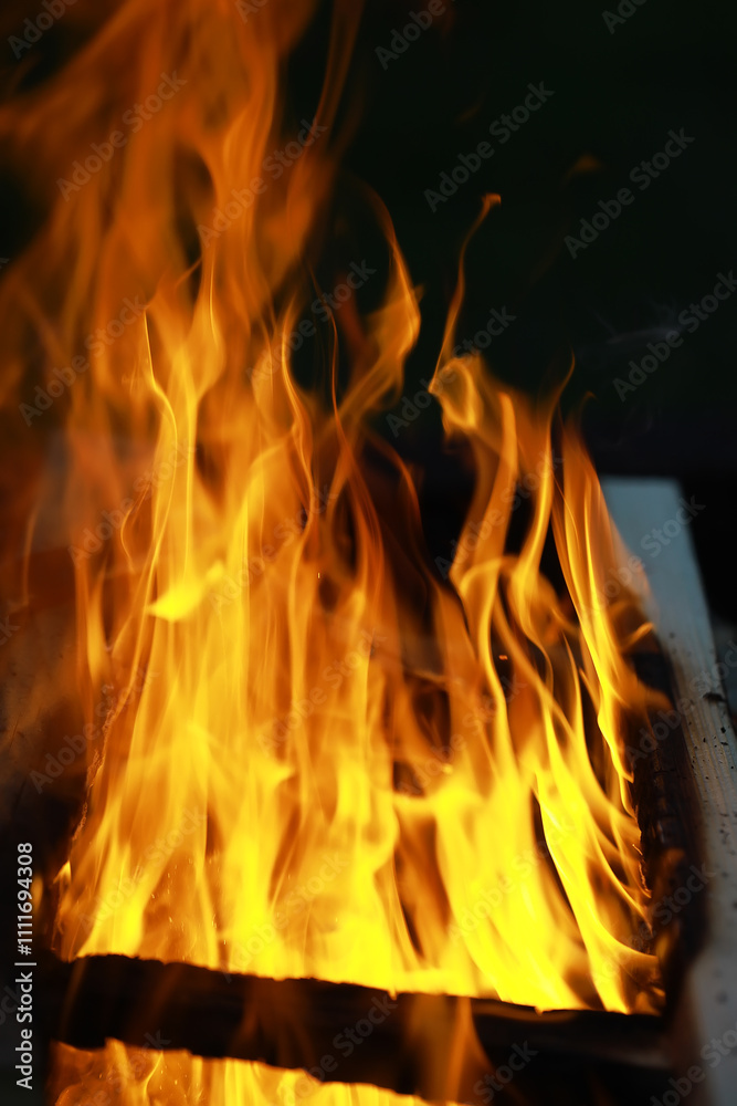 Φωτογραφία Close-up of Intense Yellow and Orange Flames Engulfing Wooden Logs in a Fireplac