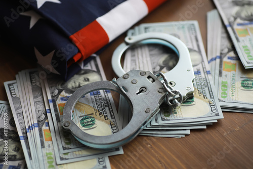 Handcuffs on American Dollars Amidst USA Flag Depicts Crime and Financial Fraud Concept