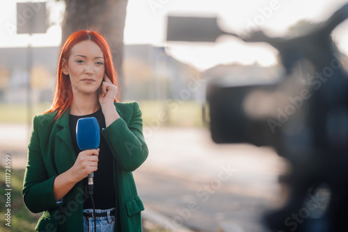 Wallpaper Mural Journalist reporting live news holding microphone and adjusting in-ear Torontodigital.ca