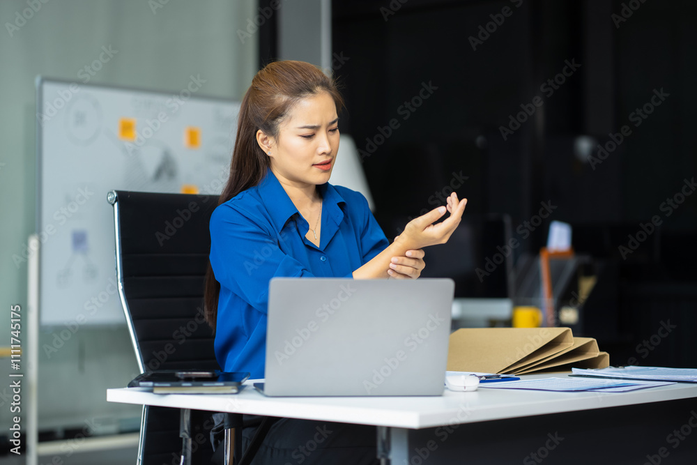 © NINENII - Business woman have wrist pain after work hard in office.