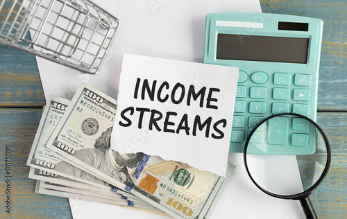 Vászonkép income streams . text on a notebook. notepad on wooden table.