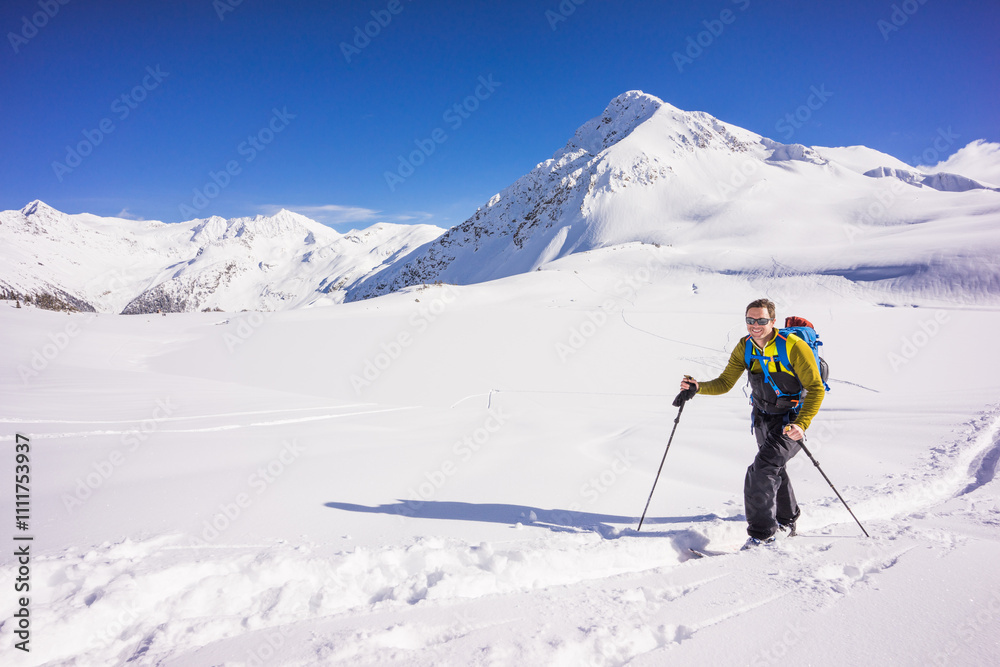 Skier skinning up track in Whistler backcountry, Canada. Skier skinning up track in Whistler backcountry, Canada.