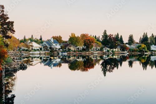 Serene lakefront neighborhood with colorful fall trees photo