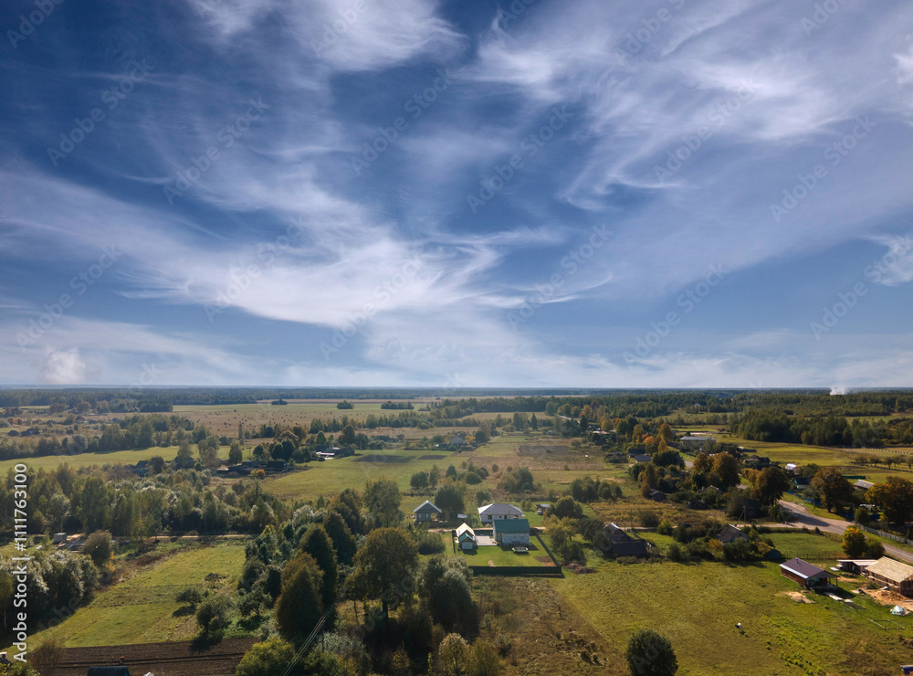 Fototapeta premium Top view of the village, landscape and houses, forest and fields from the height of a flying drone. 