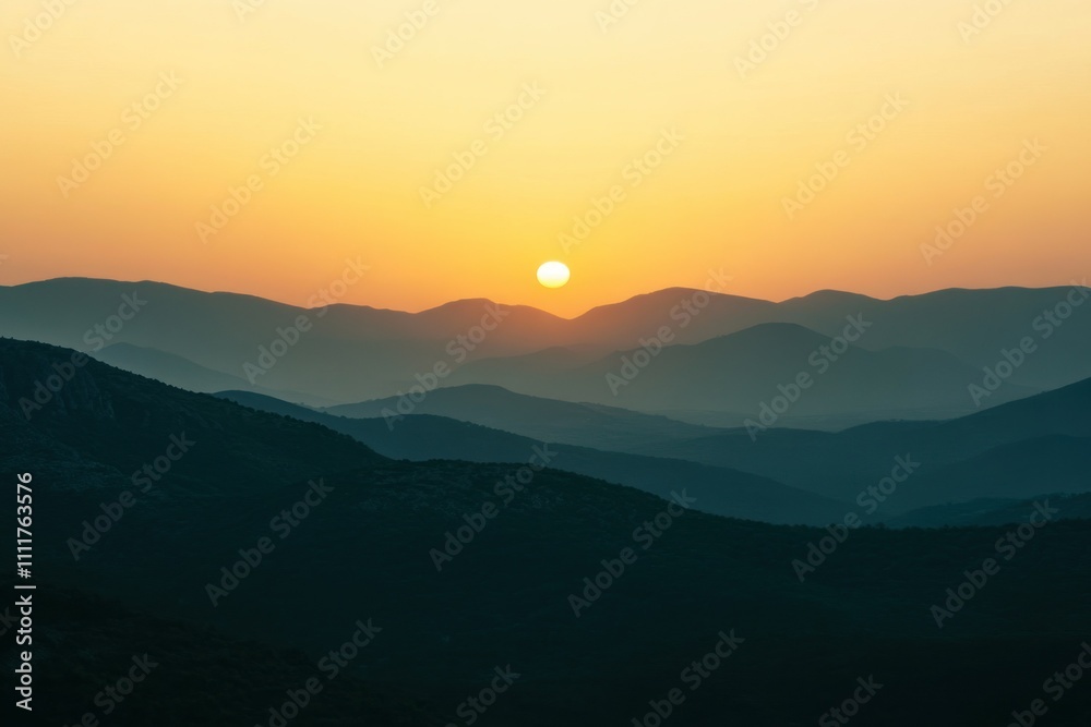 Orange and pink sunset over mountain ranges with a glowing sky Orange and pink sunset over mountain ranges with a glowing sky