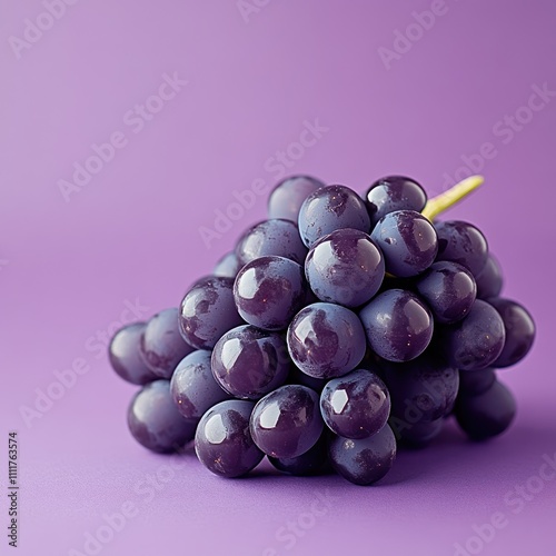 A cluster of grapes with a few falling off, isolated on a deep purple background. photo