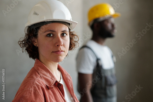 Building contractor wearing hardhat at site photo