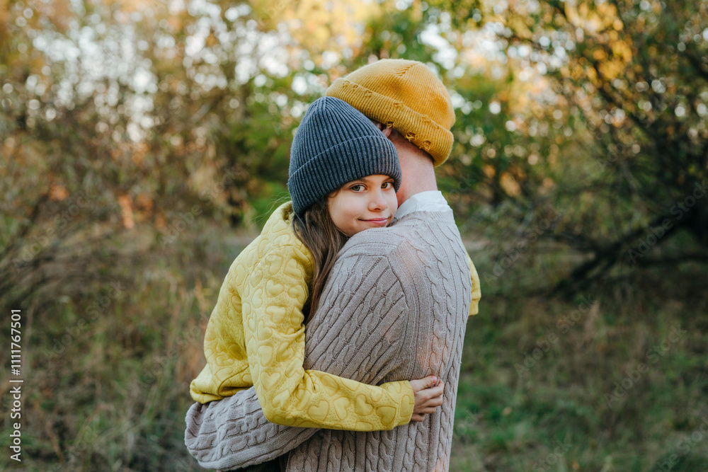 Father hugging smiling daughter in forest Father hugging smiling daughter in forest