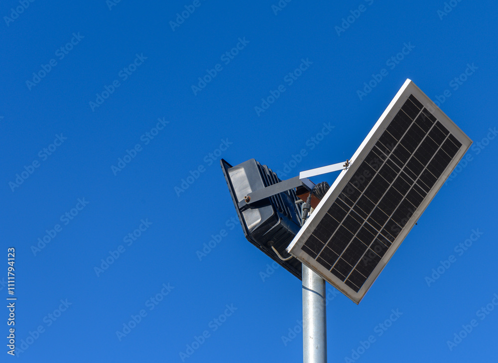 Innovative solar panel with integrated lighting system shines bright against a clear blue sky. Innovative solar panel with integrated lighting system shines bright against a clear blue sky.