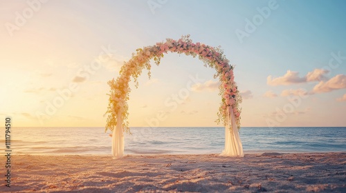 Floral wedding arch with delicate ribbons, placed on a quiet beach glowing under the golden hues of sunset. No people.