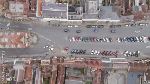 Drone view of Marlborough High Street, featuring cars driving through historic streets surrounded by vibrant shops and buildings in the United Kingdom photo