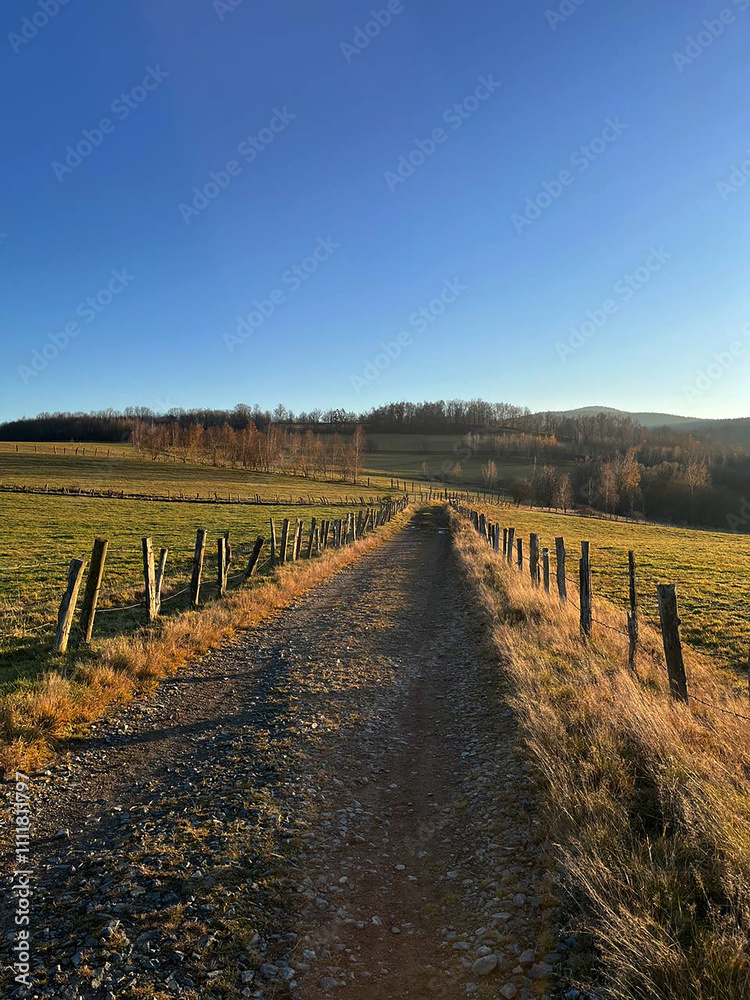Autumn sunset in the mountains, country road in the mountains. Sudetes, Poland Autumn sunset in the mountains, country road in the mountains. Sudetes, Poland