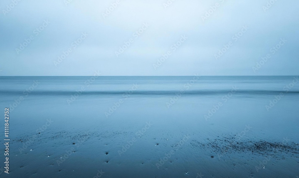 A serene seascape with a calm horizon and muted blue tones. A serene seascape with a calm horizon and muted blue tones.