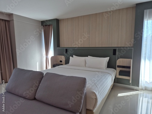 Classic and soft bed with cozy sofa in the bedroom. Modern and clean design architecture home idea. 