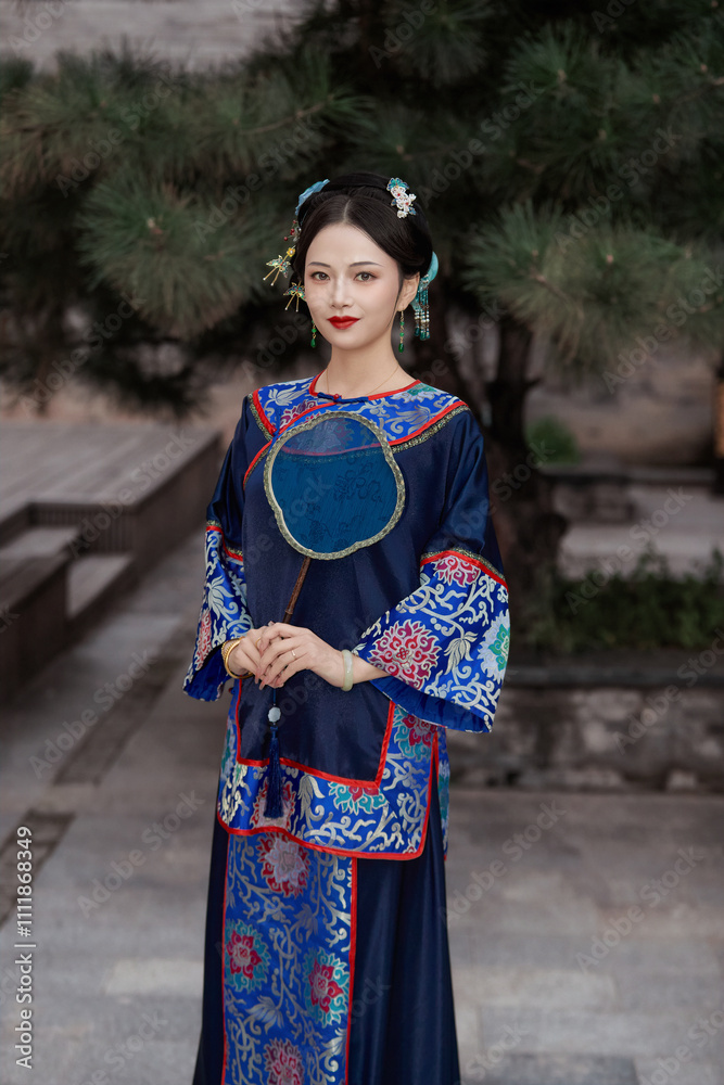 A beautiful Chinese woman wearing Chinese late Qing Dynasty clothing and holding a fan A beautiful Chinese woman wearing Chinese late Qing Dynasty clothing and holding a fan