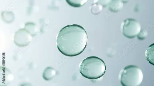 A close-up bubbles in cosmetic liquid floating on plain background. Hyaluronic acid. Crystal clear light green/mint color. Reflective liquid surface. Underwater air bubbles. photo