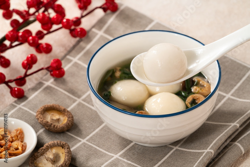 Eating big tangyuan yuanxiao with savory soup in Taiwan. photo