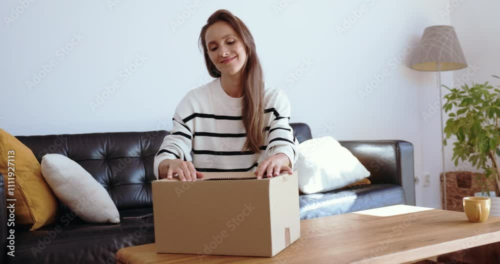 Woman packing sweater for delivery reselling used clothes. Woman packing sweater for delivery reselling used clothes.