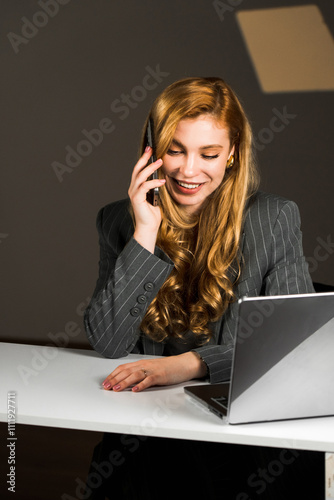 A charismatic woman with red hair is talking on the phone. A call center worker is talking on the phone. Call service concept