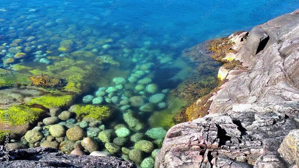 The Barents Sea. Beach in Teriberka, dragon eggs. Waves roll onto the beach with dragon eggs. Rounded stones lying on the shore of the North Sea. Kola Peninsula, Murmansk. The Barents Sea. Beach in Teriberka, dragon eggs. Waves roll onto the beach with dragon eggs. Rounded stones lying on the shore of the North Sea. Kola Peninsula, Murmansk.