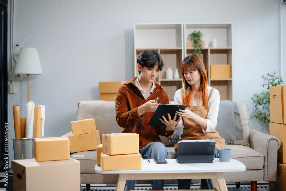 Asian man and woman working at home office, BOX, tablet and laptop online, marketing, packaging, delivery. Asian man and woman working at home office, BOX, tablet and laptop online, marketing, packaging, delivery.