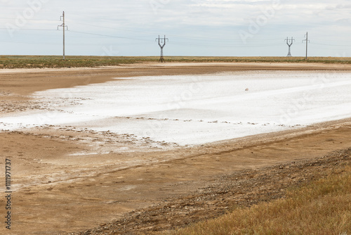 Bright salt flats under a cloudy sky in Kazakhstan's steppe landscape during summer