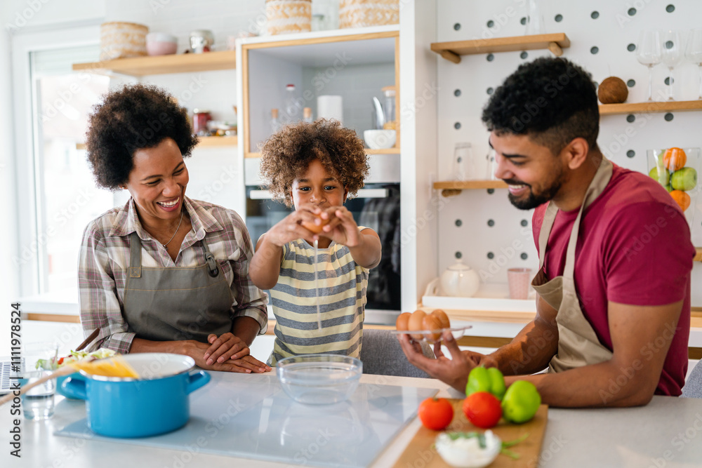Happy african american family preparing healthy food in kitchen, having fun together on weekend Happy african american family preparing healthy food in kitchen, having fun together on weekend