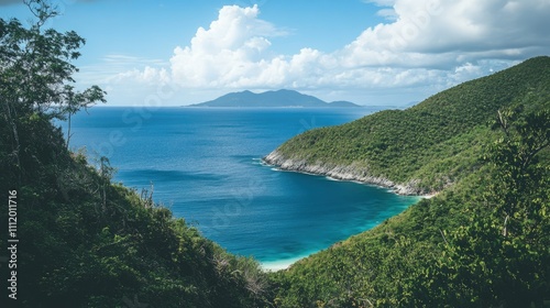 Secluded cove with turquoise water, lush green hills, and distant island under a blue sky.