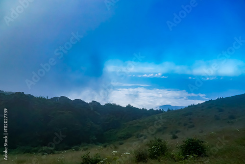 Breathtaking landscape view of rolling hills and clouds in nature tranquil setting wide angle scenic beauty