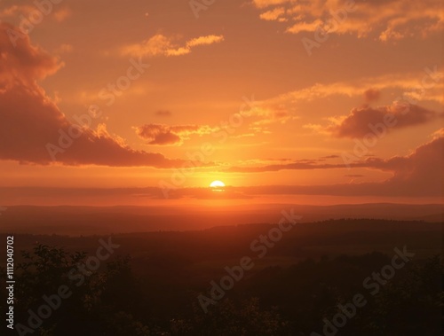 Warm golden light illuminates the sky as the sun approaches its final moments on the horizon , golden sunset sky, peaceful landscape, afternoon, daybreak