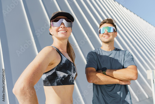 Energetic outdoor fitness enthusiasts posing in activewear against a bright background