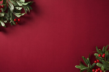 Festive red and green holiday border frame with berries and branches. Ideal for Christmas-themed designs and seasonal marketing