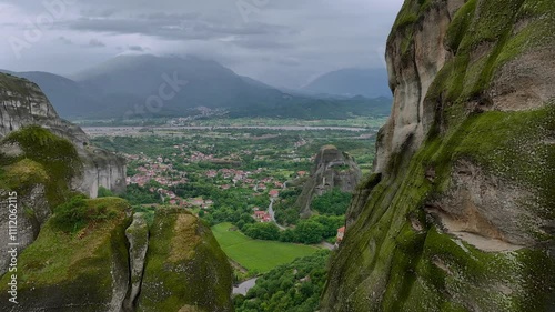 Drone flight among cliffs of the Meteora Valley and the small picturesque towns of Kastraki and Kalampaka at their foot, Greece