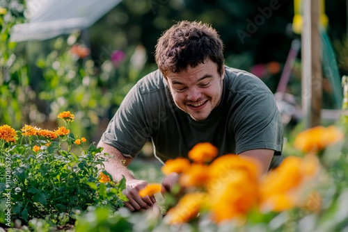Young man with down syndrome gardening marigold flowers in community garden