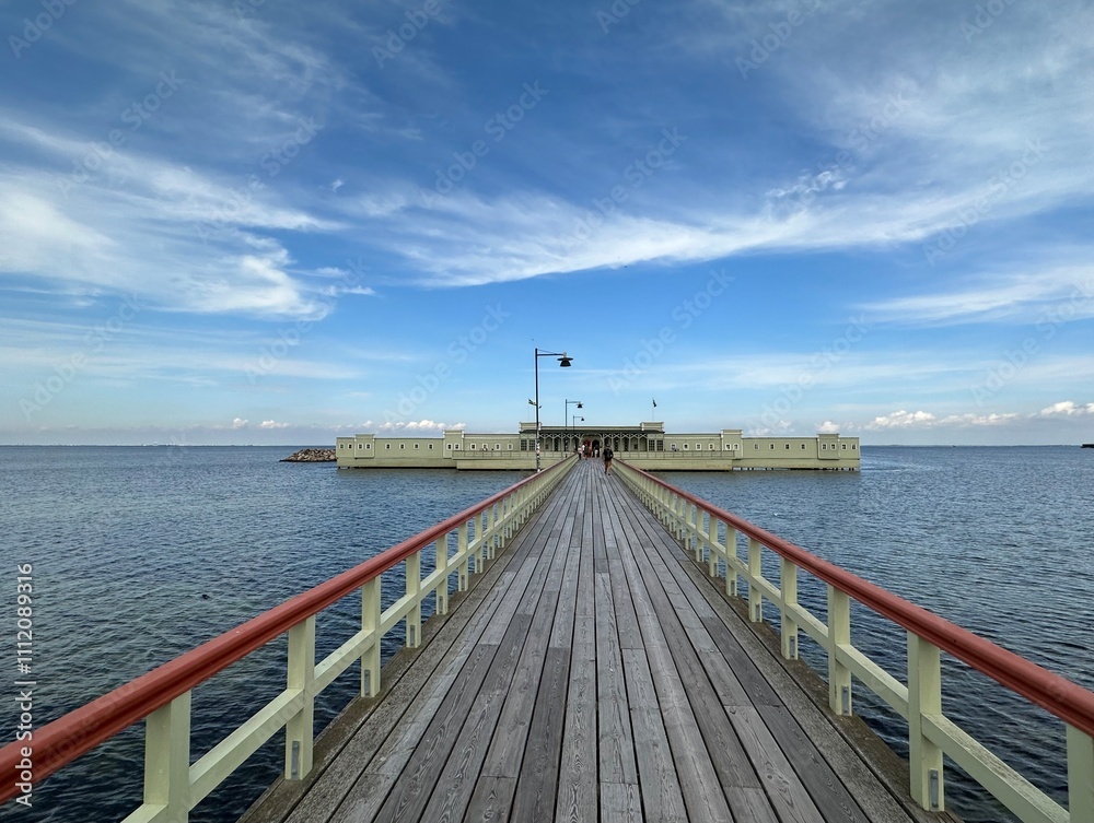 Obraz premium Historic wooden pier leading to the Ribersborg open-air bathhouse, Malmo, Skåne, Sweden, August 2023