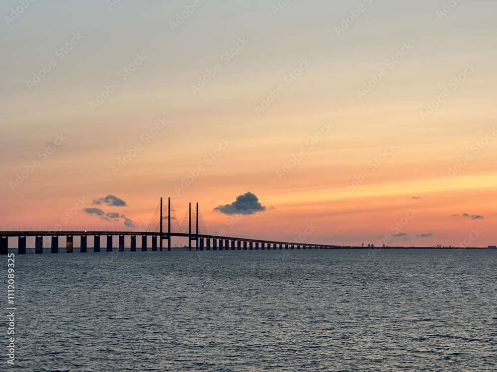 Øresund Bridge across the Øresund strait between Denmark and Sweden during sunset near Malmö, Skåne, Sweden, August 2023