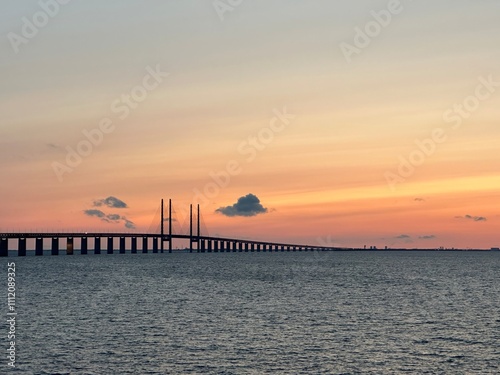 Øresund Bridge across the Øresund strait between Denmark and Sweden during sunset near Malmö, Skåne, Sweden, August 2023 photo