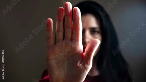 Stop violence against women, stop woman abuse. Woman with raised hand for dissuade