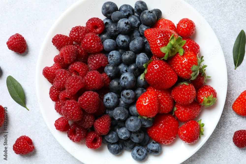 Different fresh ripe berries in bowl on the table Different fresh ripe berries in bowl on the table