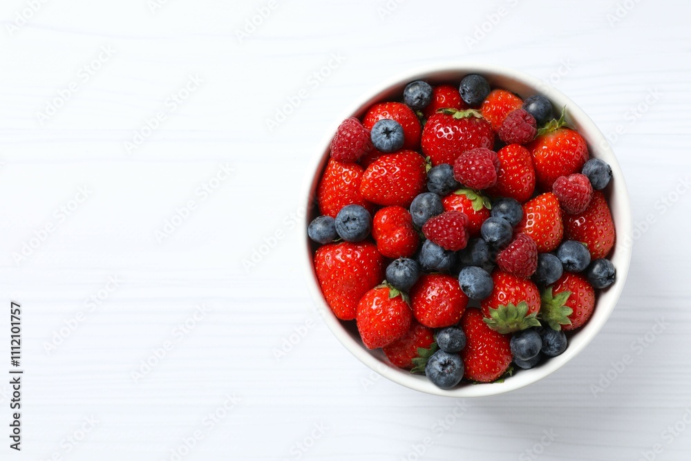 Different fresh ripe berries in bowl on the table Different fresh ripe berries in bowl on the table