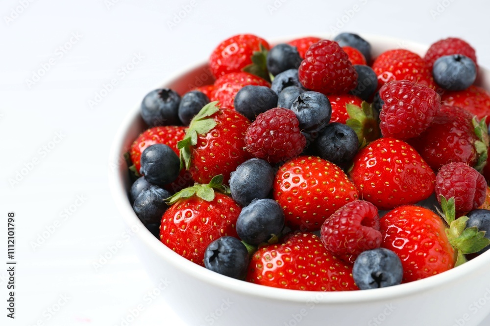 Different fresh ripe berries in bowl on the table Different fresh ripe berries in bowl on the table