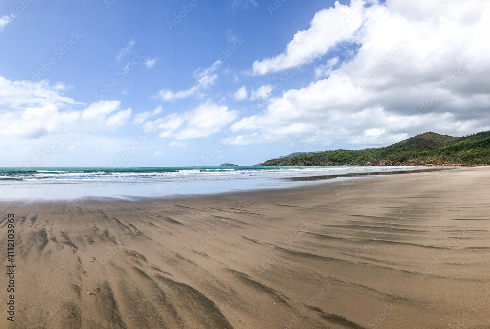 A Stunningly Serene Beach Landscape with Gentle Waves and a Beautiful Blue Sky Hovering Above It A Stunningly Serene Beach Landscape with Gentle Waves and a Beautiful Blue Sky Hovering Above It