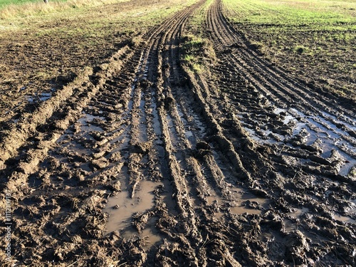 Muddy field with big tyre tracks on a sunny day in November, North Yorkshire, England , United Kingdom